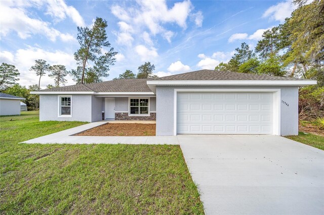 ranch-style house with a garage and a front lawn