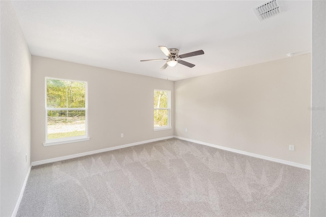 unfurnished room with light carpet and ceiling fan