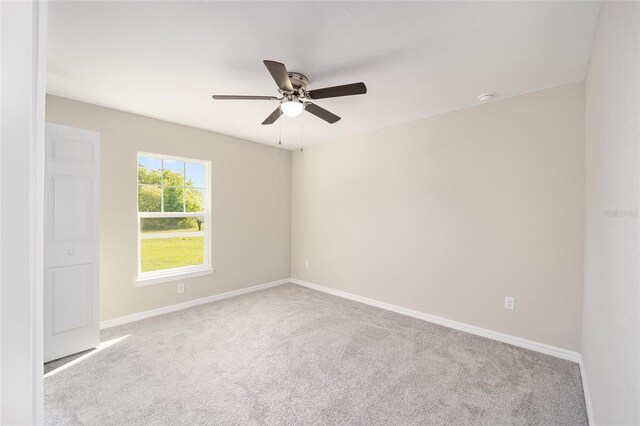 unfurnished room featuring light carpet and ceiling fan