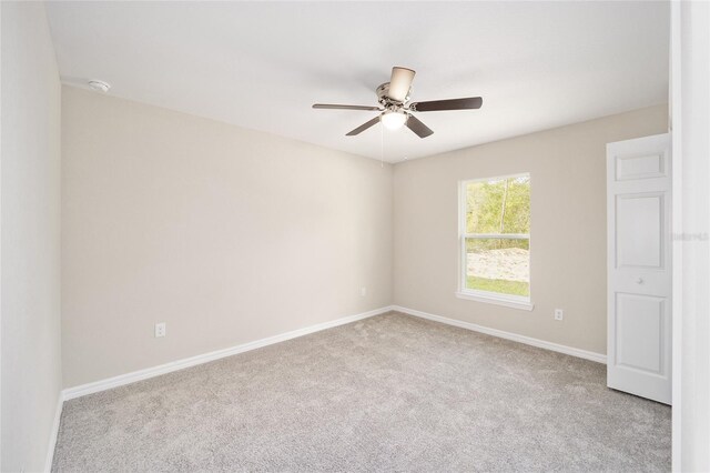 unfurnished room with ceiling fan and light colored carpet