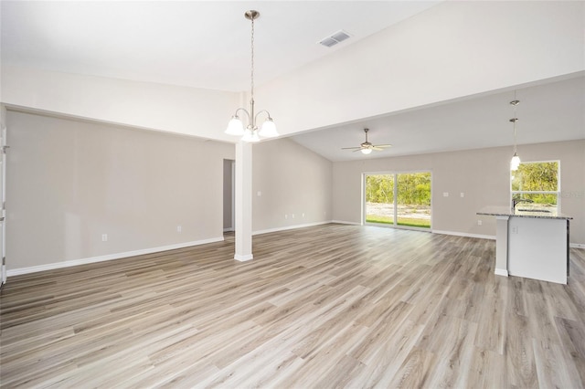 unfurnished living room with high vaulted ceiling, ceiling fan with notable chandelier, and light wood-type flooring