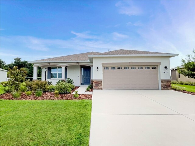 view of front of home featuring a garage and a front yard