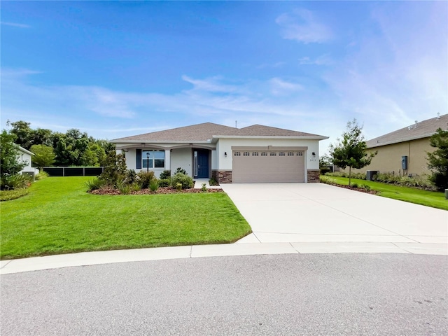 view of front of home with a front yard and a garage