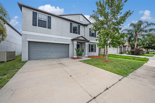 view of front of property with a garage and a front lawn