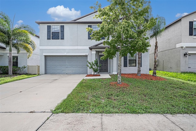 view of front property with a garage and a front yard