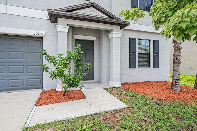 view of exterior entry featuring a garage