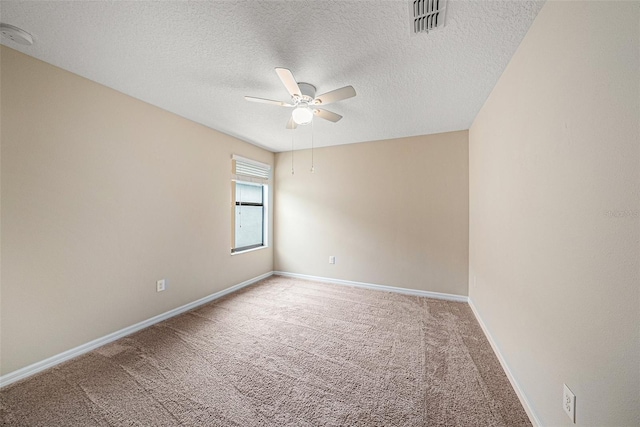 carpeted spare room featuring a textured ceiling and ceiling fan