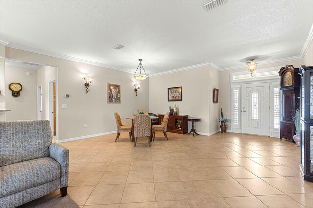 tiled dining room featuring ornamental molding and a textured ceiling