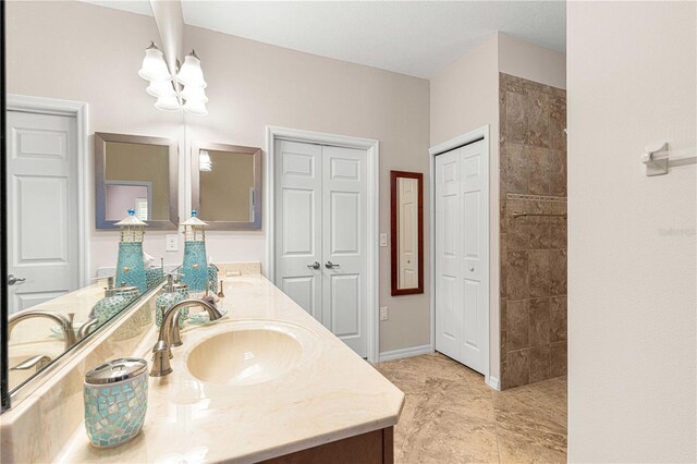 bathroom with vanity and an inviting chandelier