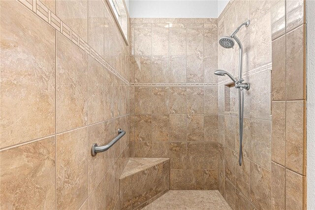 bathroom featuring a tile shower