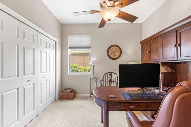 carpeted home office with ceiling fan