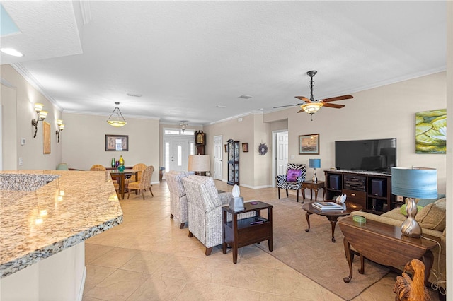 living room featuring ceiling fan, ornamental molding, a textured ceiling, and light tile patterned floors