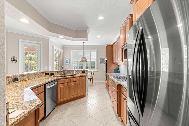 kitchen featuring appliances with stainless steel finishes, decorative light fixtures, sink, crown molding, and light stone countertops