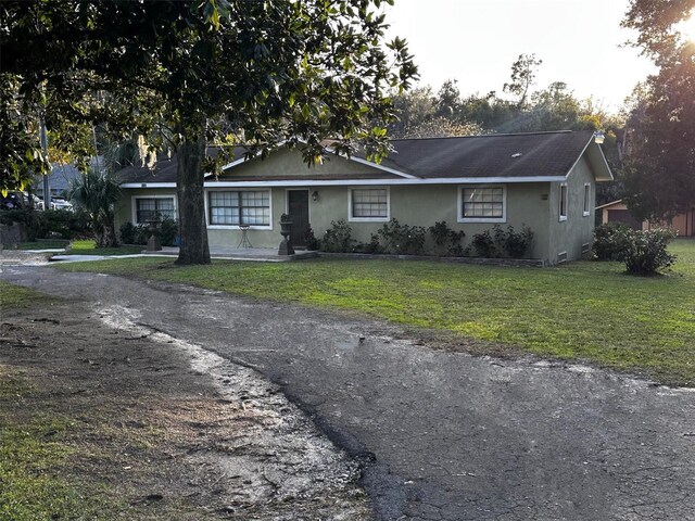 ranch-style house with a front lawn