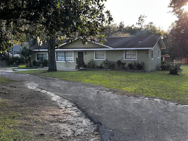 ranch-style home with a front yard