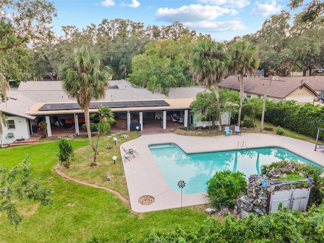 view of swimming pool featuring a yard, a patio area, fence, and a fenced in pool