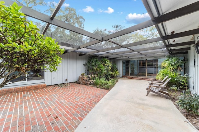 view of patio featuring glass enclosure