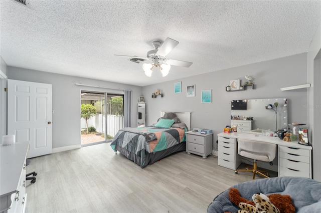 bedroom featuring ceiling fan, light wood-type flooring, access to outside, and a textured ceiling