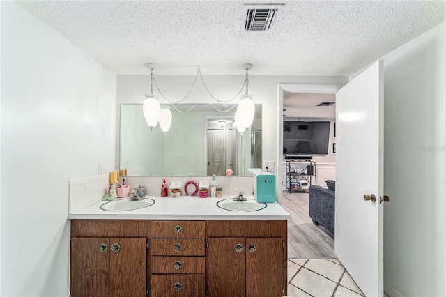 bathroom featuring a textured ceiling, hardwood / wood-style flooring, and vanity