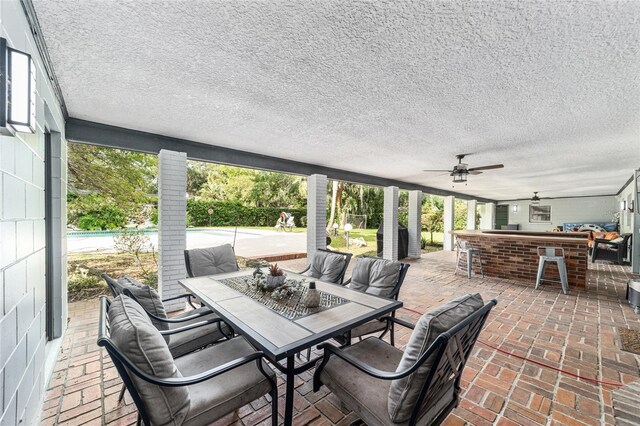 view of patio featuring ceiling fan, a swimming pool, and an outdoor living space