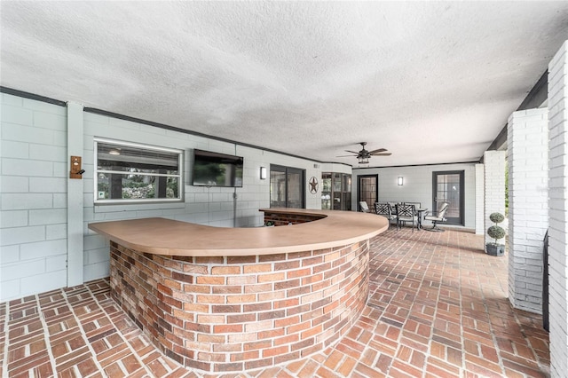 view of patio / terrace with ceiling fan and exterior bar