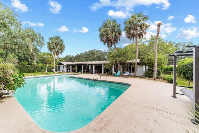 view of swimming pool featuring a pergola and a patio