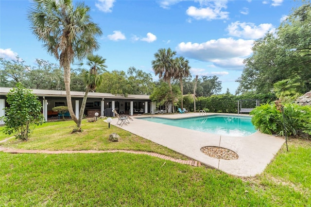 view of swimming pool featuring a fenced in pool, a yard, and a patio