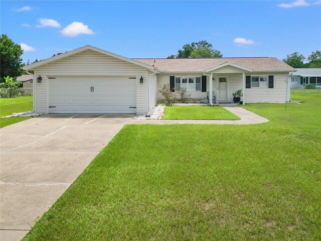 single story home with a front yard and a garage