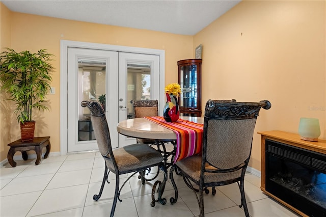 dining space with french doors and light tile patterned flooring