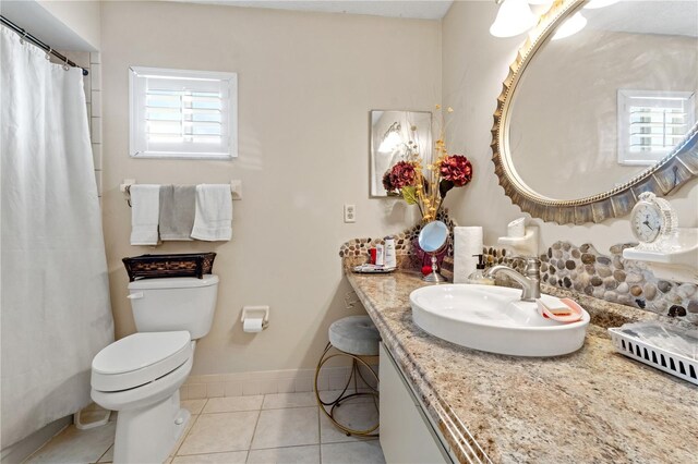 bathroom featuring toilet, vanity, and tile patterned floors