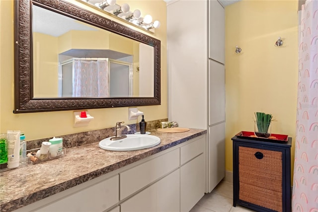 bathroom with tile patterned floors, walk in shower, and vanity