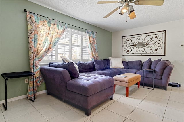 living room with ceiling fan, light tile patterned flooring, and a textured ceiling