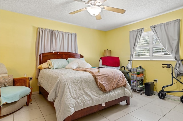 tiled bedroom with a textured ceiling and ceiling fan