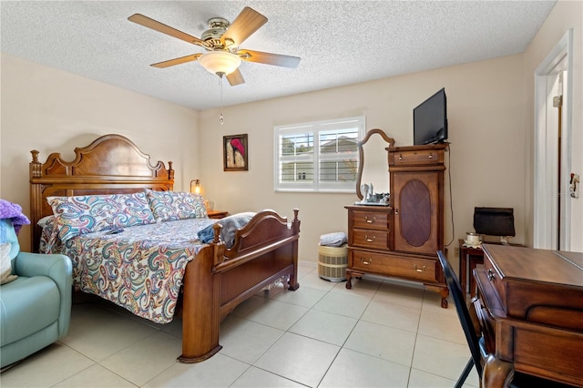 tiled bedroom featuring a textured ceiling and ceiling fan