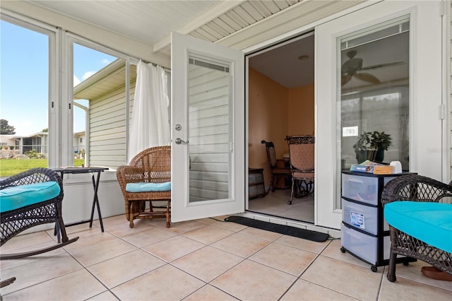 sunroom / solarium with ceiling fan and a healthy amount of sunlight