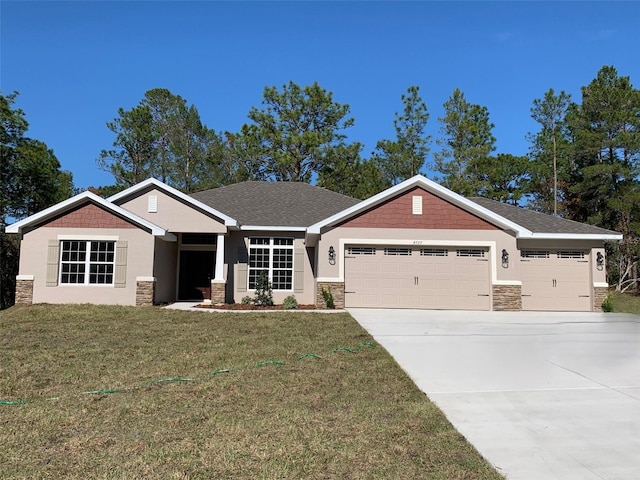 craftsman inspired home with a garage and a front lawn