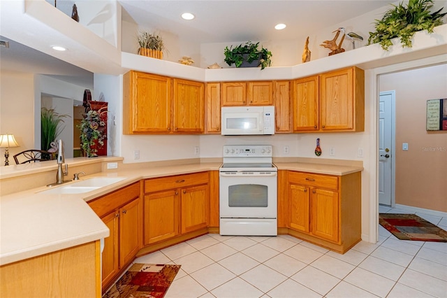 kitchen with white appliances, kitchen peninsula, sink, and light tile patterned floors