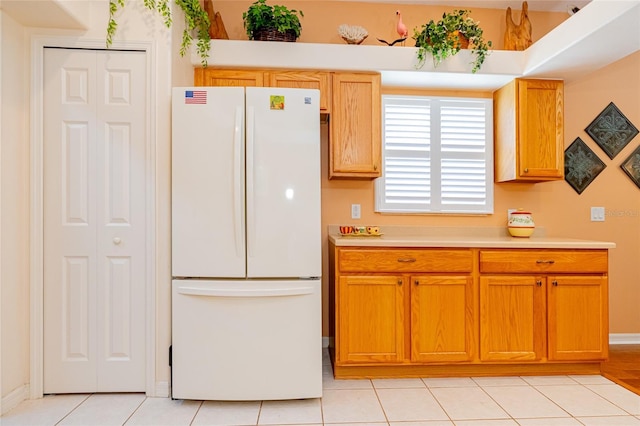 kitchen featuring white fridge and light tile patterned floors