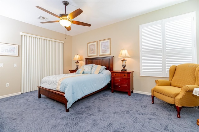 bedroom featuring ceiling fan, light colored carpet, and multiple windows