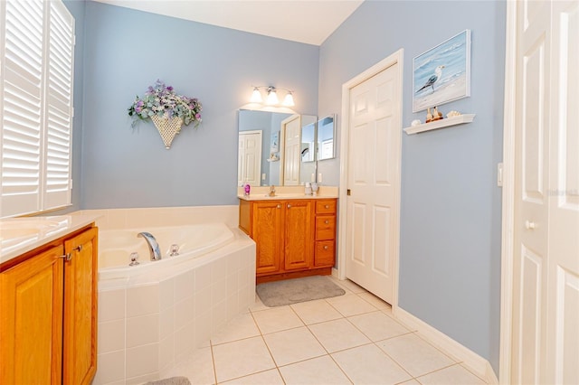 bathroom featuring vanity, tiled tub, and tile patterned floors