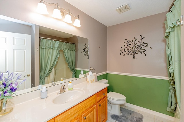 bathroom featuring tile patterned floors, toilet, and vanity