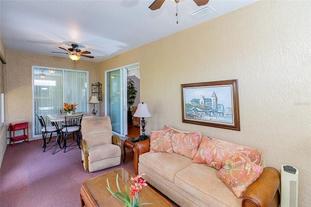 carpeted living room featuring ceiling fan