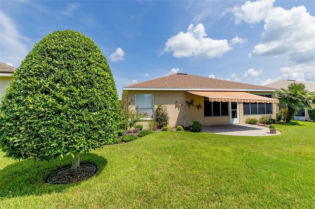 rear view of property with a patio and a lawn