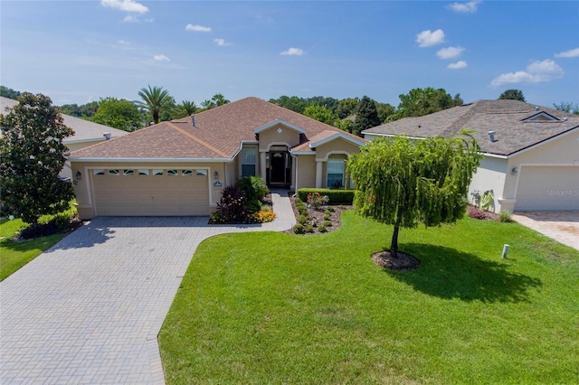 view of front of house with a garage and a front lawn