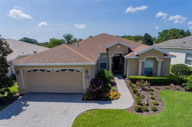 ranch-style home with a garage and a front yard