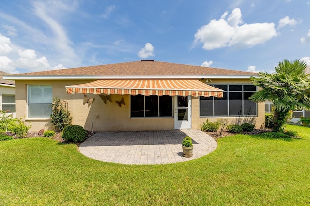 back of property featuring a yard and a patio area