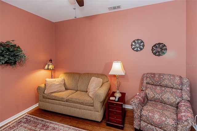 living room featuring hardwood / wood-style flooring and ceiling fan