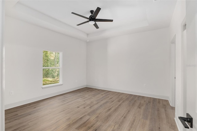 5 Emerald Trl, Ocala, FL 34472 - unfurnished room featuring baseboards, a raised ceiling, light wood-style flooring, and ceiling fan