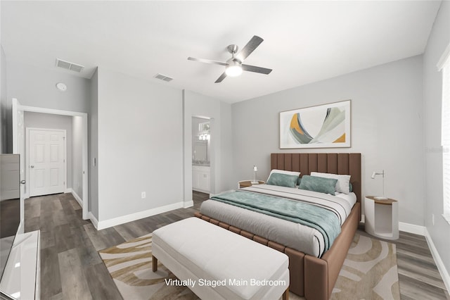 bedroom featuring connected bathroom, dark wood-type flooring, and ceiling fan