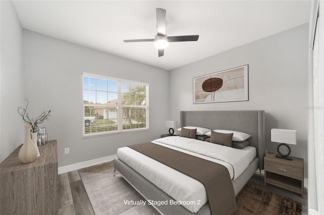 bedroom with ceiling fan and dark hardwood / wood-style flooring